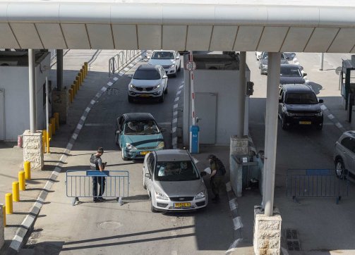 An Israeli car drives across the Qalandiya checkpoint to enter Jerusalem