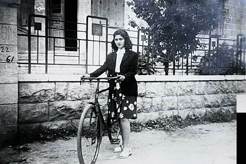 Abla Dajani Daoudi in front of her family house in Lower Baq‘a in 1943