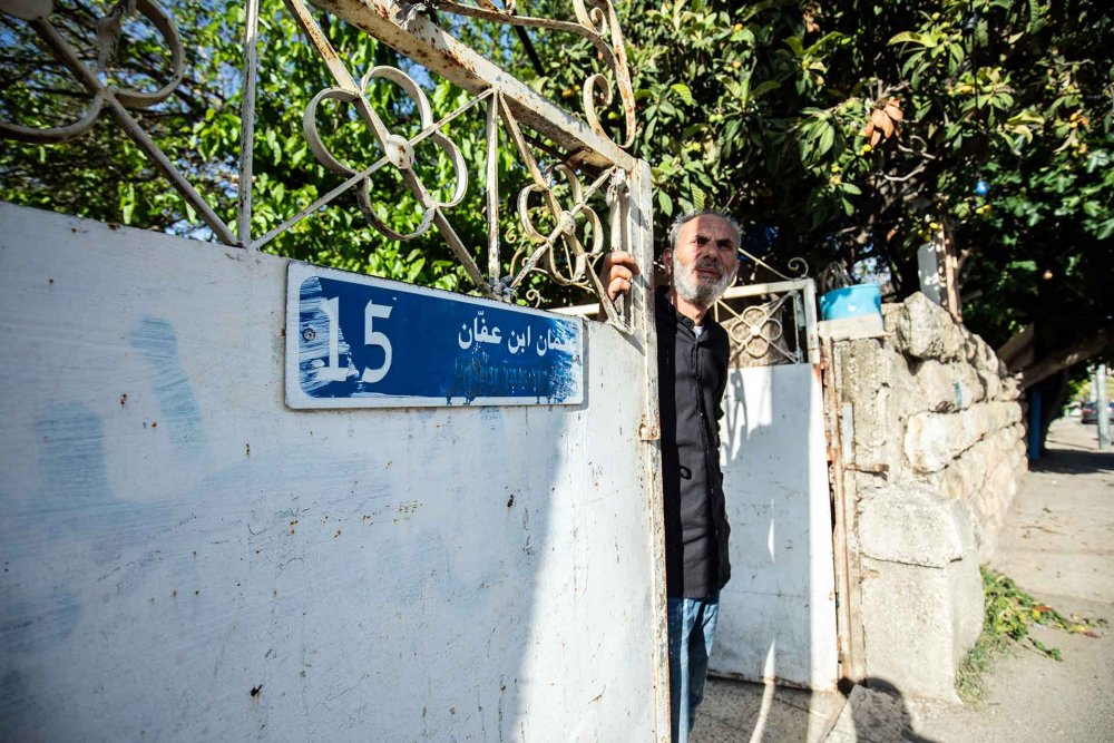 Saleh Diab peers out of the gate of his family home in Sheikh Jarrah, East Jerusalem, April 17, 2024.