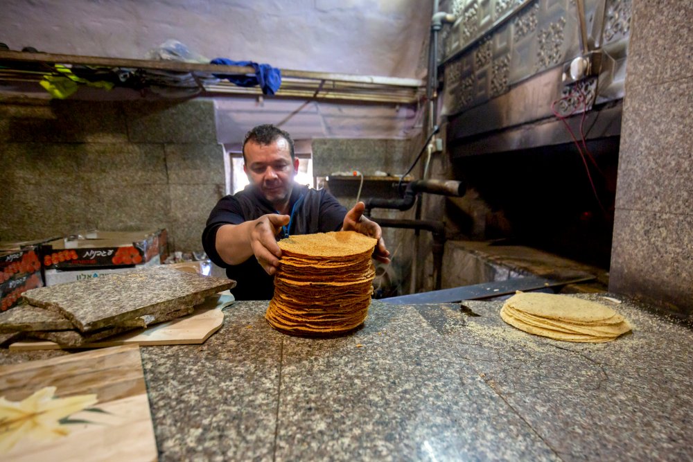 A baker in the Old City preparing barazeq, traditionally eaten during Ramadan