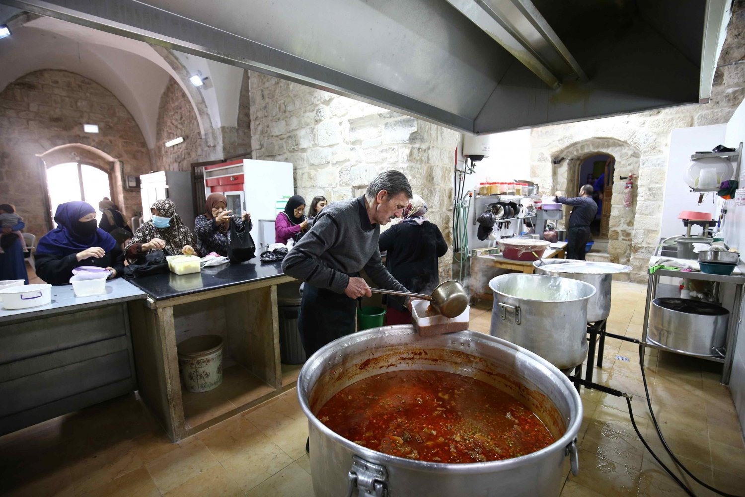Cooks prepare food in the Khaski Sultan community kitchen in the Old City of Jerusalem 