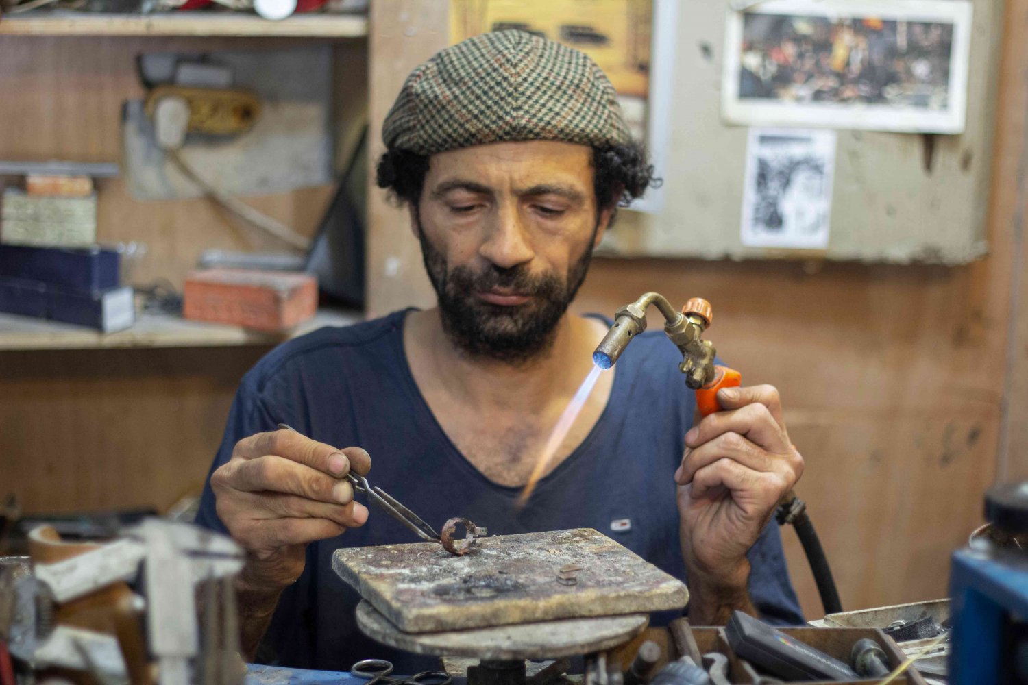 A metal worker focuses in the Old City of Jerusalem, 2021