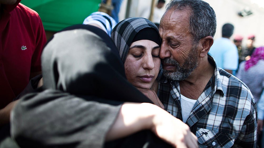 A released Palestinian prisoner hugs relatives, October 18, 2011, Ramallah, West Bank.
