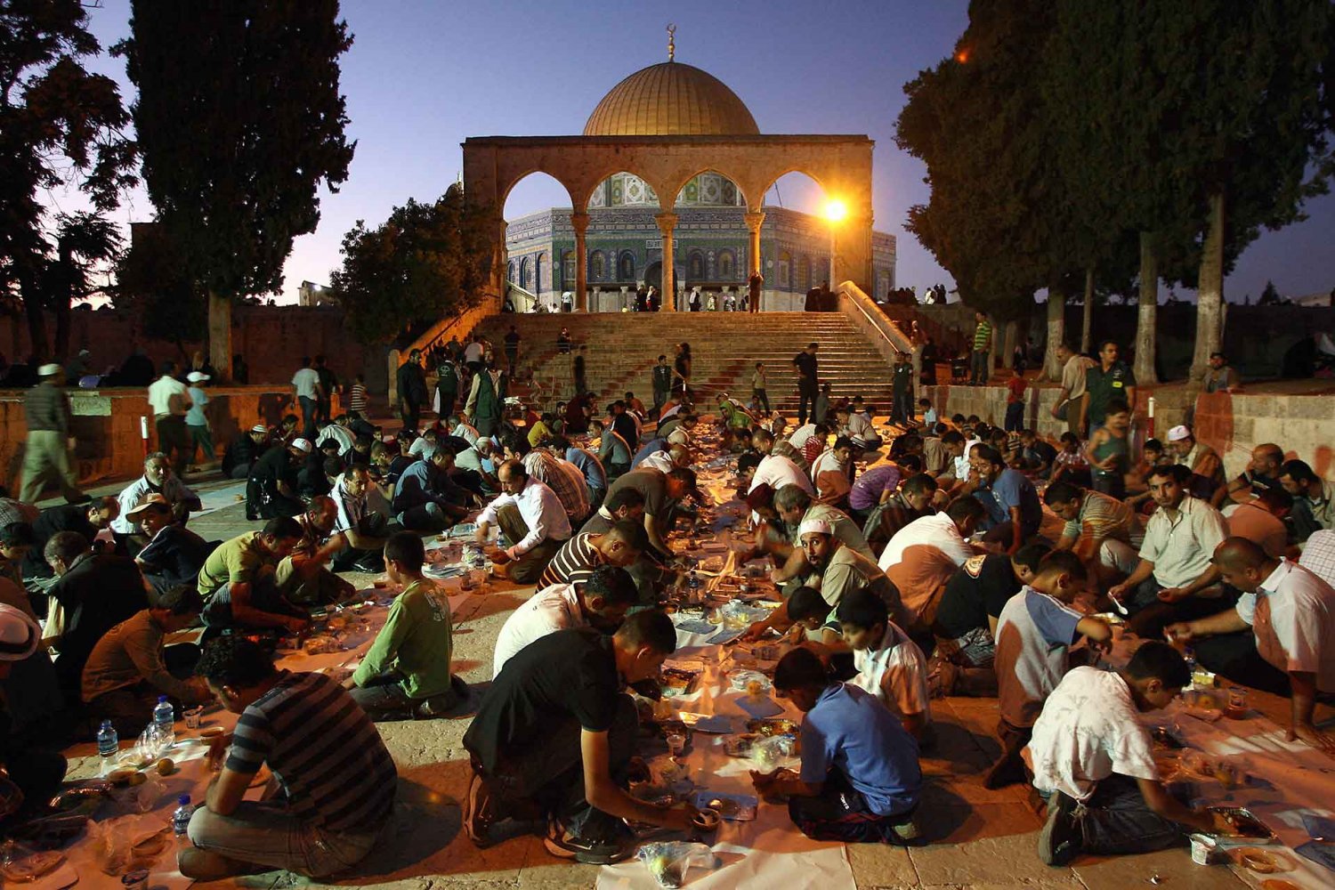 Palestinian during a charity Ramadan iftar feast outside the Dome of the Rock in Jerusalem, August 27, 2009.