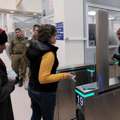 Palestinians proceed through the new biometric turnstile at Qalandiya checkpoint, 2019.