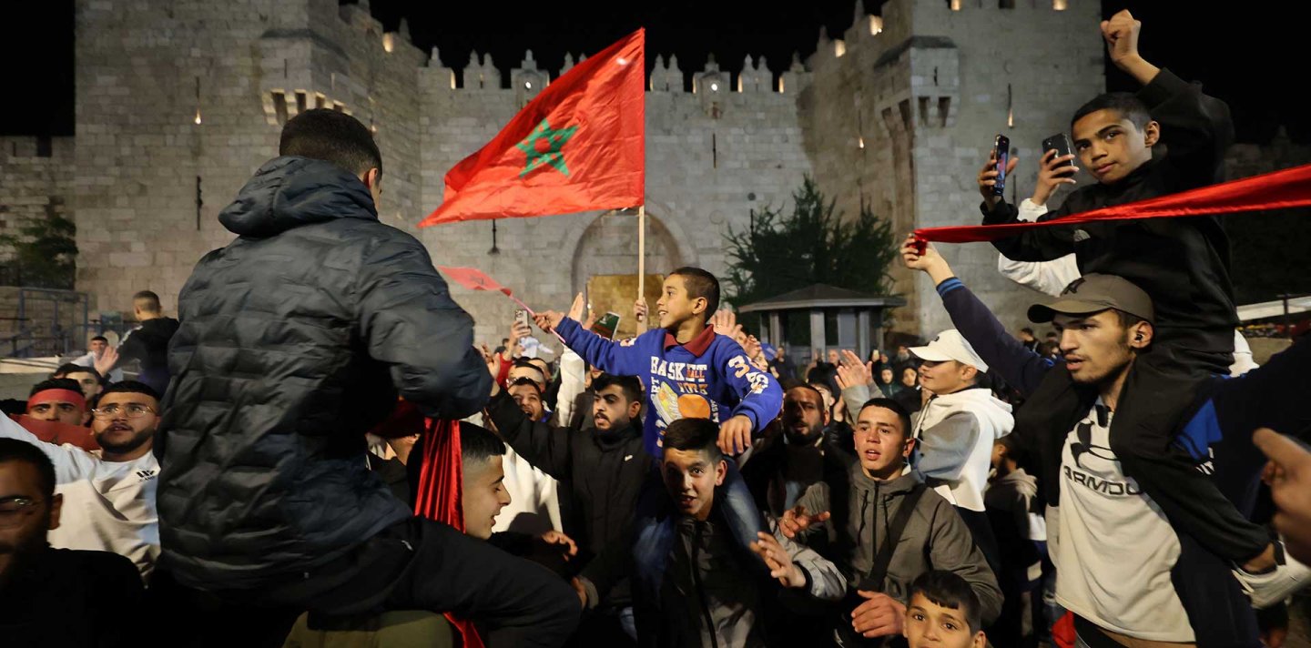 Palestinians celebrate Morocco's win at the World Cup in front of Jerusalem's Damascus Gate
