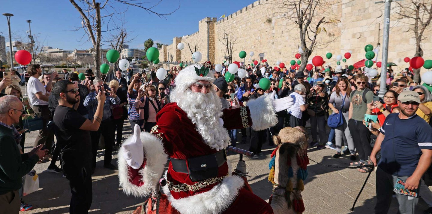 Santa Claus tours Jerusalem's Old City on a camel
