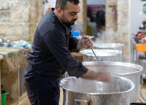 The assistant cooks help prepare mansaf in the Khaski Sultan soup kitchen in the Old City of Jerusalem, 2022