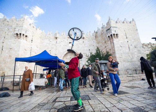 Palestinian street circus performer Ahmad Ju‘beh performs with his unicycle at Damascus Gate.