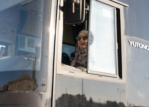 Samia Abu ‘Alqam Shawafta at the wheel of her bus, the number 73, which travels the Shu‘fat–Beit Hanina route in East Jerusalem, April 26, 2023