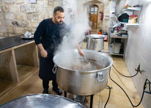 A Palestinian chef prepares meat for the dish mansaf at a soup kitchen in Jerusalem’s Old City during Ramadan, March 20, 2024.