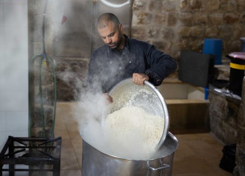 Cooked rice is served for a Ramadan meal for the needy at a public soup kitchen in Jerusalem’s Old City, March 20, 2024.