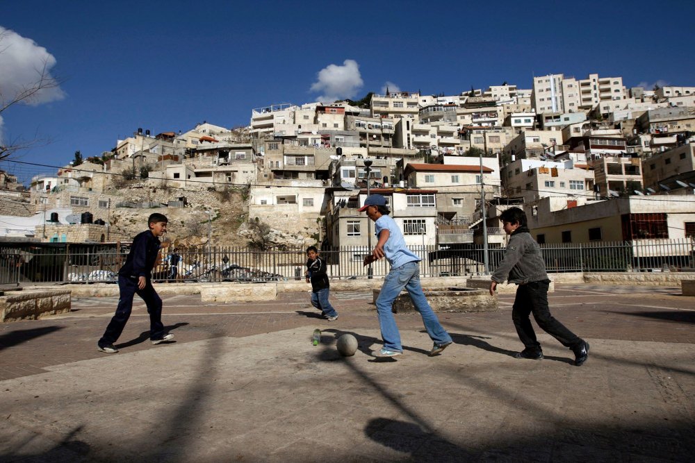 Palestinian boys play soccer in the neighborhood of Silwan, a focus of Israeli settlement and confiscation