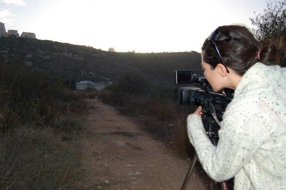 Filmmaker Mahasen Nasser-Eldin filming on location in Palestine