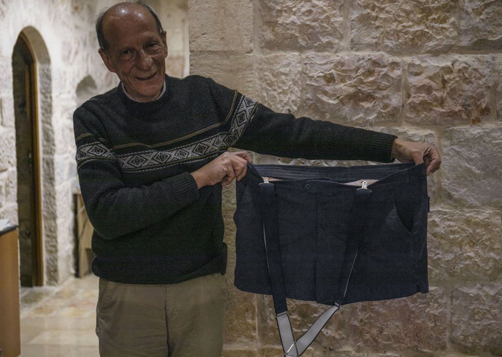 Yacoub Abu Arafeh displays the original shorts used for the Nakhleh Esheber puppet show in his office in Sheikh Jarrah