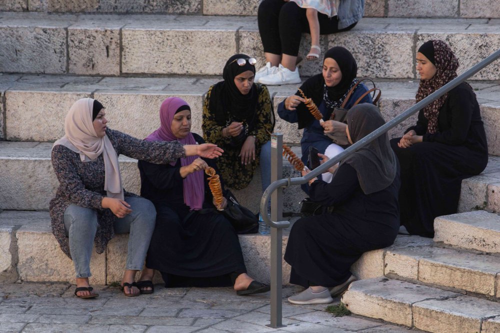 Palestinian women socialize on the steps at Damascus Gate, Old City of Jerusalem