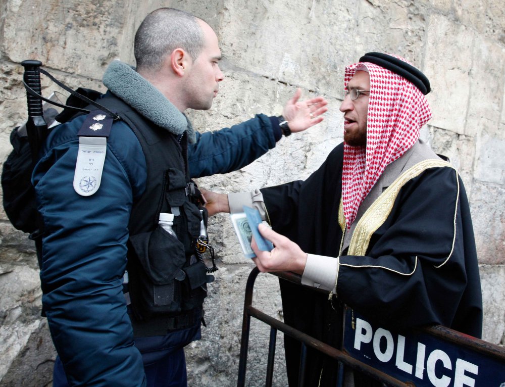A Muslim man argues with police at the entrance to al-Aqsa Mosque in the Old City of Jerusalem, 2021
