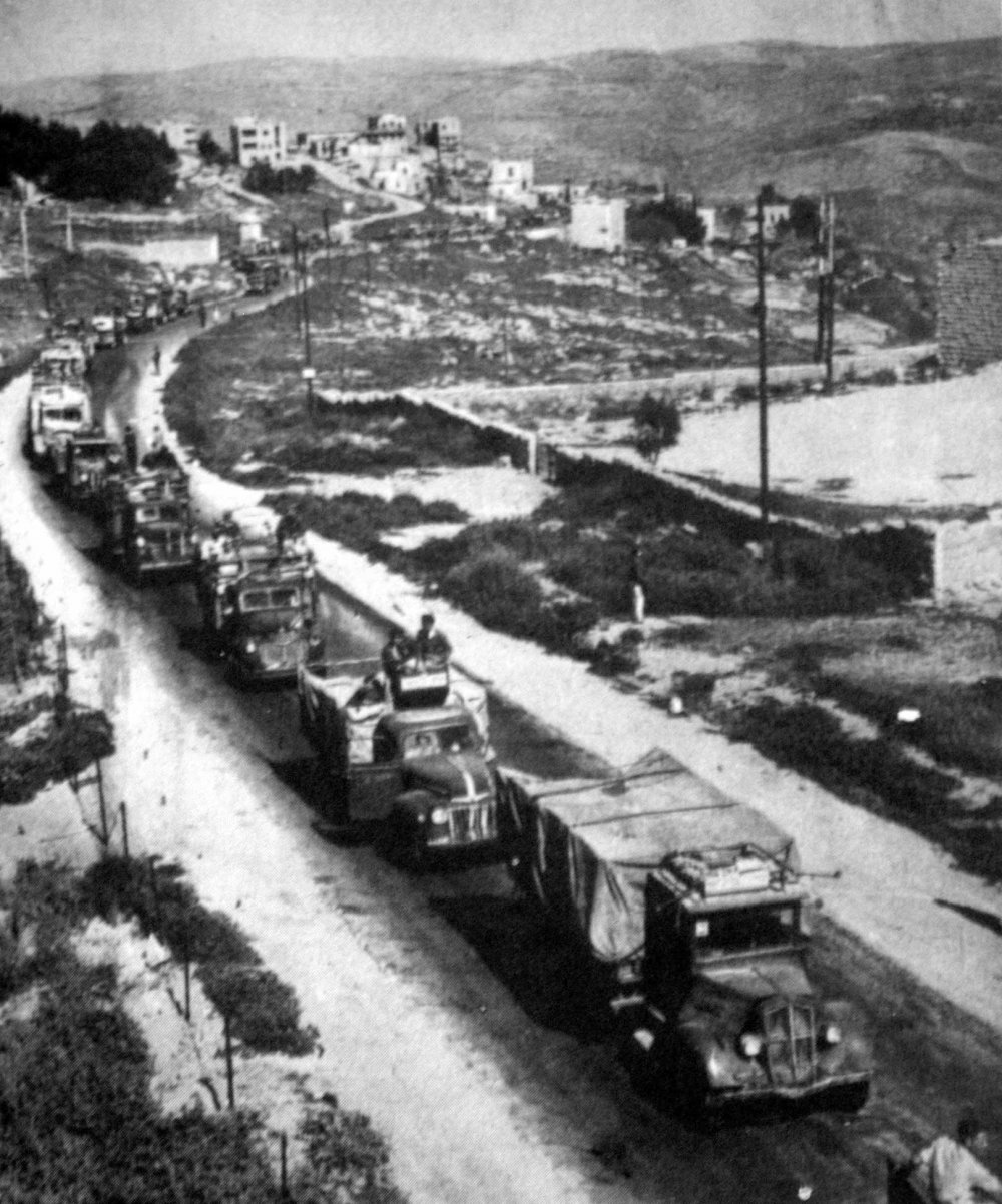 A supply convoy reaches the outskirts of Jerusalem, passing by Lifta, approximately April 20, 1948.