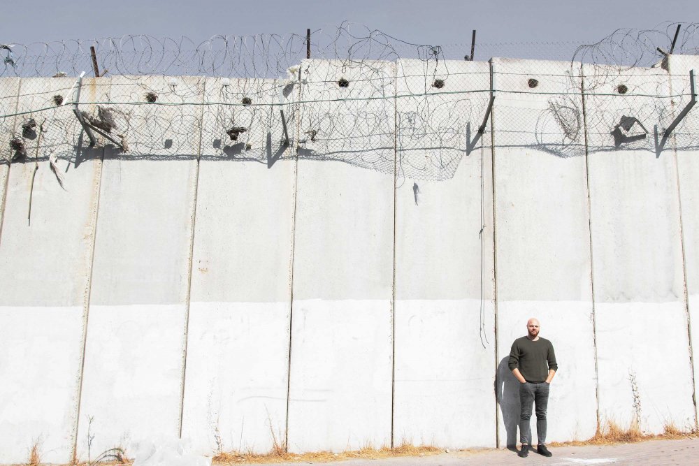 Zaid Abu Dalu stands in front of the Separation Wall