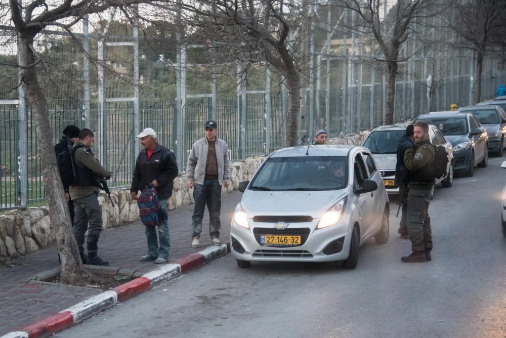 Israeli border police stop Palestinian drivers at a flying checkpoint in the al-Tur neighborhood of East Jerusalem, 2016
