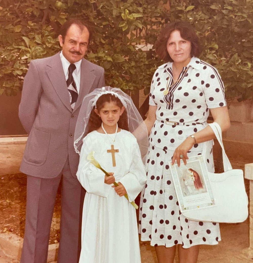 Shireen Abu Akleh with her parents during her first communion, in 1979