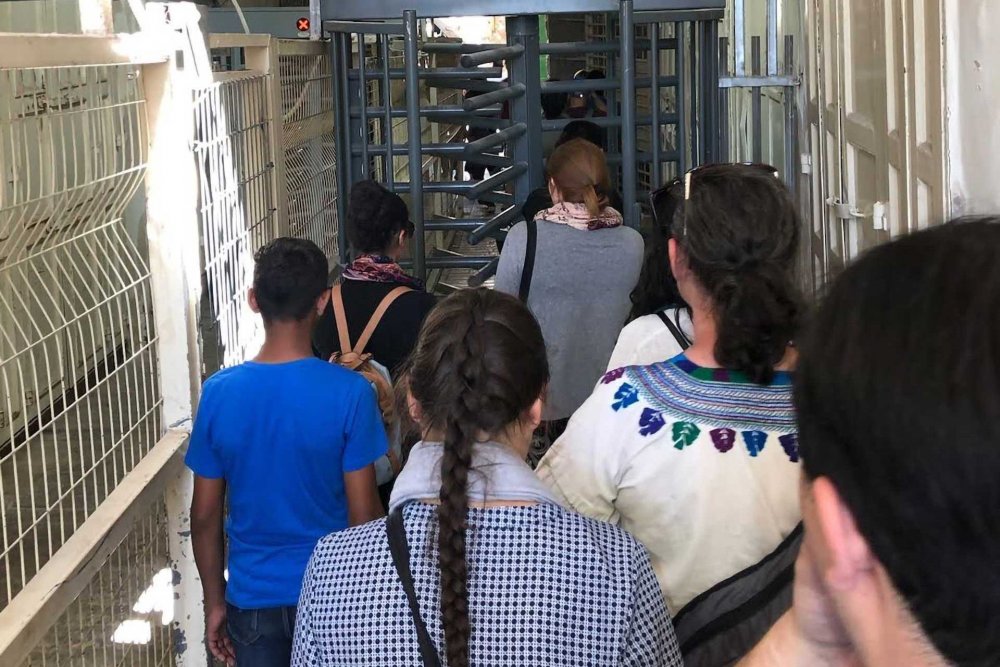 Philip Farah leading a delegation through a Hebron checkpoint in the West Bank