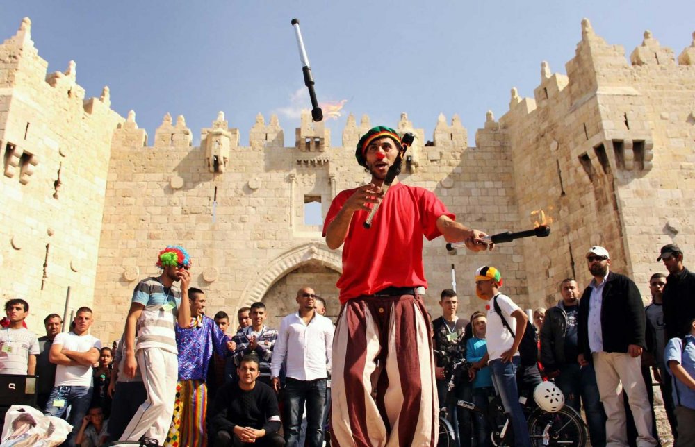 Palestinian street circus artist Ahmad Ju‘beh shows off his juggling skills in front of the ancient Damascus Gate in Jerusalem’s Old City.