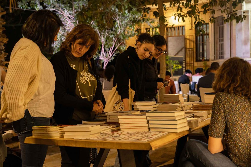 Attendees browsing the book table at an event that was part ofPalFest2023 in Jerusalem on May 21, 2023.