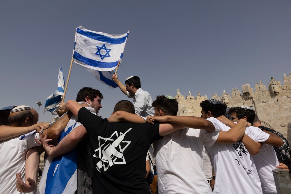 Israeli youth dance and celebrate outside Damascus Gate in Jerusalem on Flag Day, 2022.