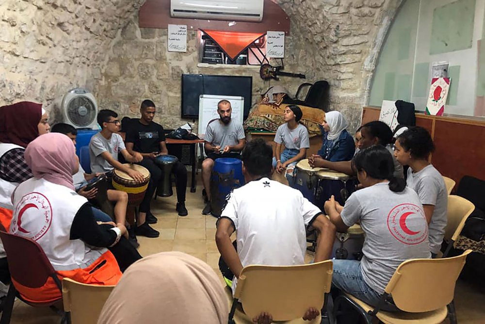 Drumming lessons for youth at the African Community Society center in Jerusalem's Old City