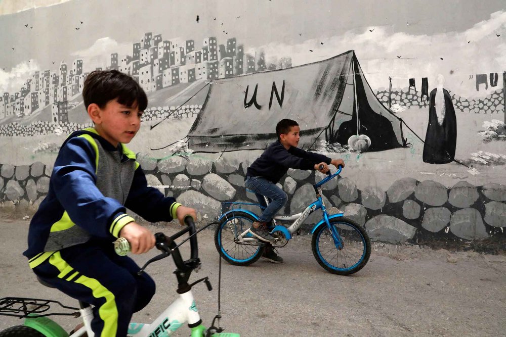 Palestinian children riding their bicycles in the al-Fawwar refugee camp southwest of Hebron.
