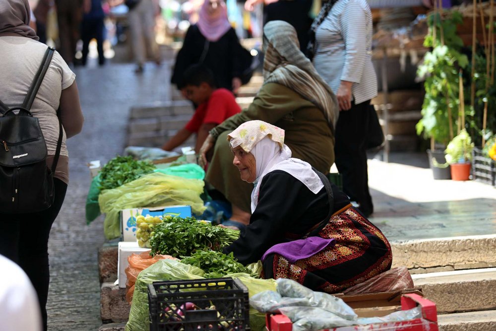 Palestinian woman selling herbs and vegetables in Jerusalem’s Old City