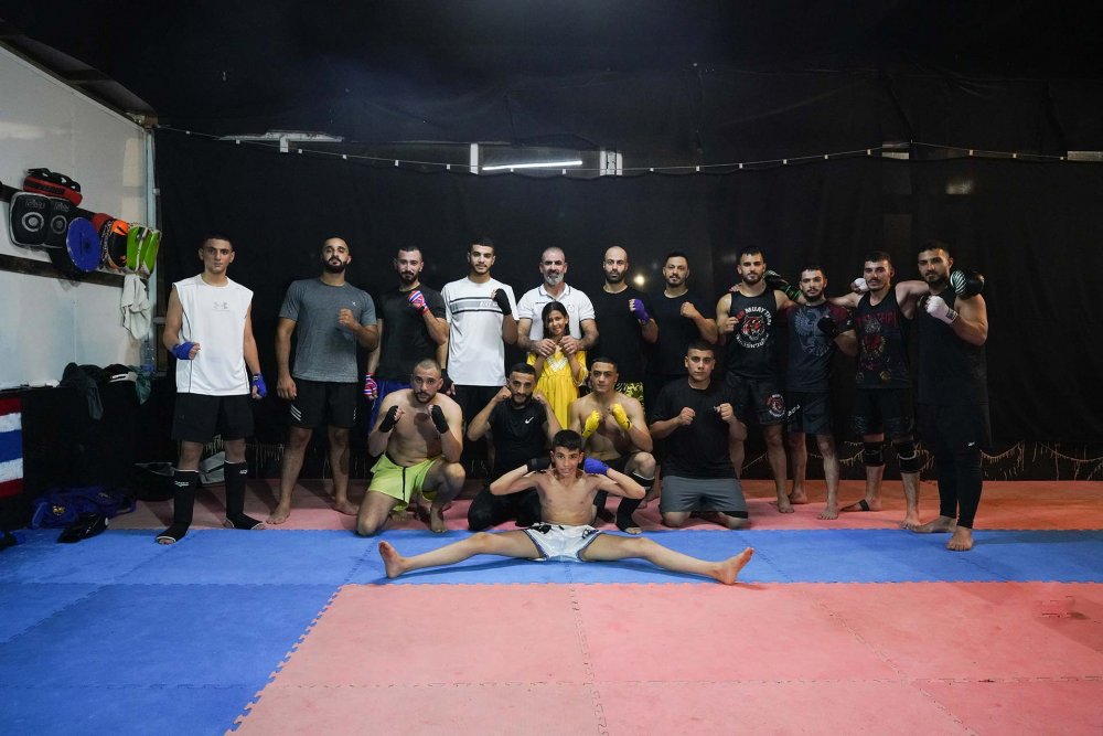 Trainees of Muay Thai in Jerusalem with coach Fadi Mustafa at al-‘Isawiyya club in Jerusalem, August 2023