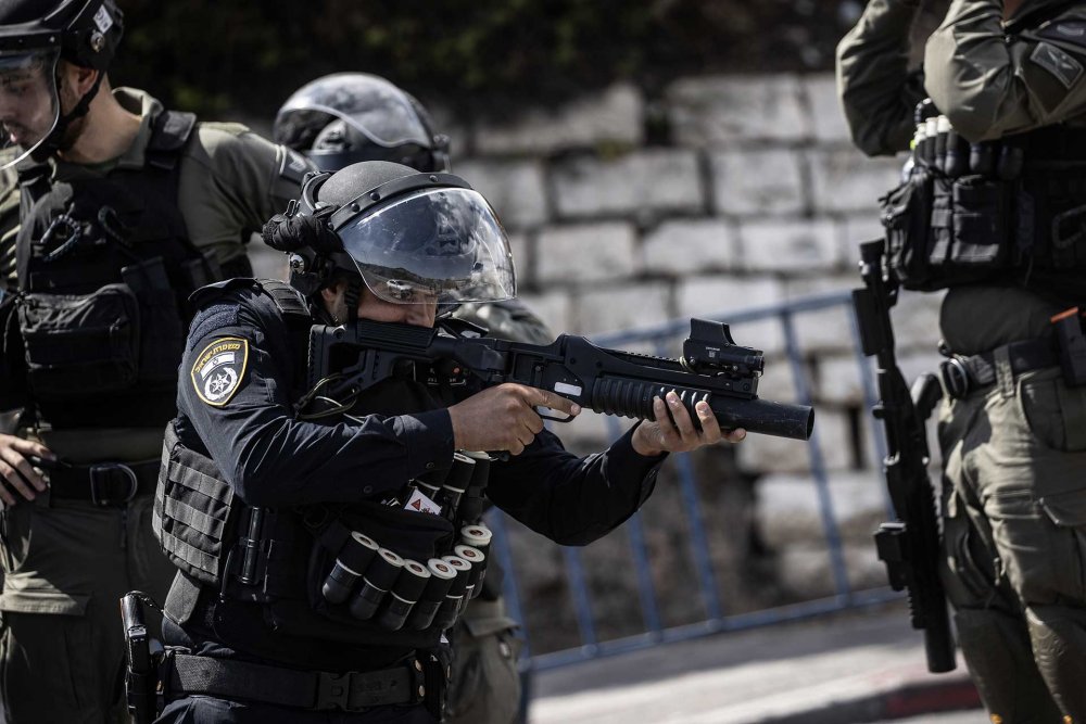 Israeli police fire tear gas on Palestinians in the Ras al-Amud neighborhood, where men barred from entering the al-Aqsa Mosque gathered to pray on October 20, 2023, during Israel's war on Gaza.