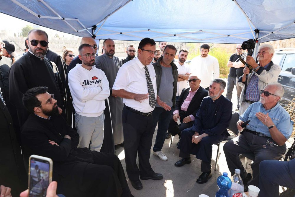 Attorney Kevork Nalbanian updates the Armenian Patriarchate, clergy, and community members about the implications of the case in the sit-in tent set up in the Armenian parking lot, November 16, 2023.