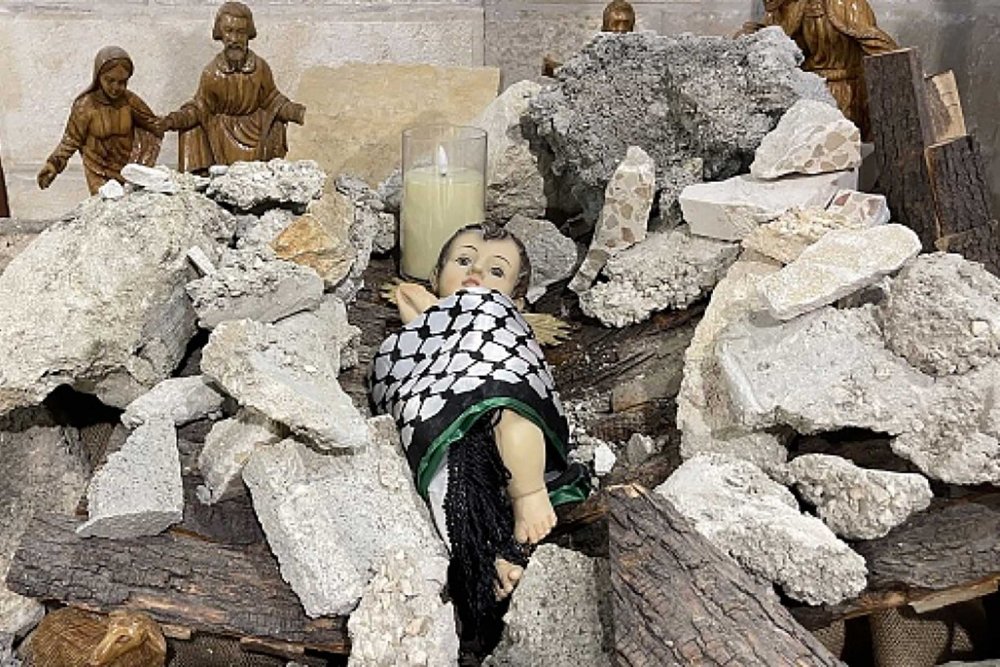 The 2023 nativity scene depicting a baby Jesus swaddled in a Palestinian kuffiyeh, lying in the rubble