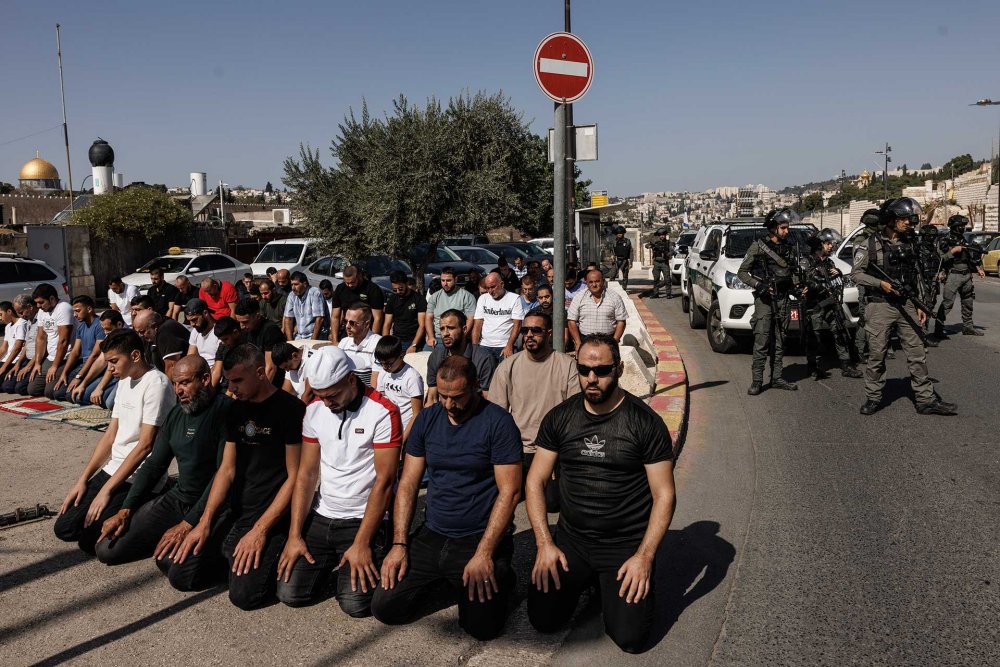 Palestinian men barred from al-Aqsa Mosque due to Israel’s imposed age restrictions on entry prayed along the streets in the neighborhood of Ras al-Amud outside of the Old City under the gaze of Israeli police, November 3, 2023.