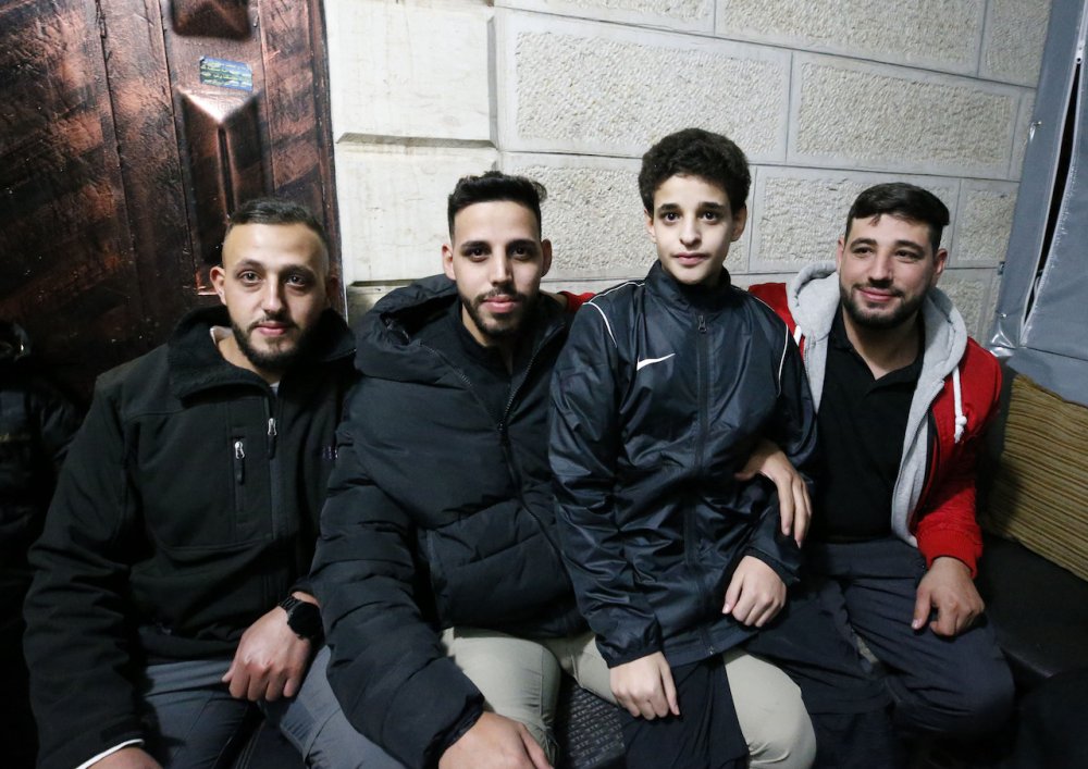 Izz al-Din Mutasim Tutah (second from the right), 14, released as part of a swap deal between Israel and Hamas, reunites with his family in Wadi al-Joz, Jerusalem, November 30, 2023.