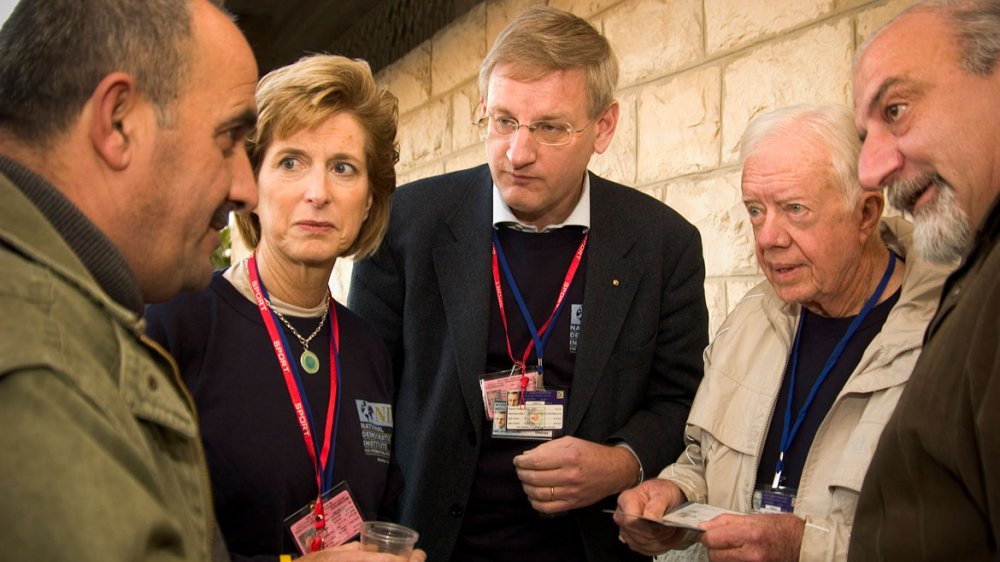 A team of international observers from the Carter Center speak with a Palestinian voter during the January 9, 2005, Palestinian election. 