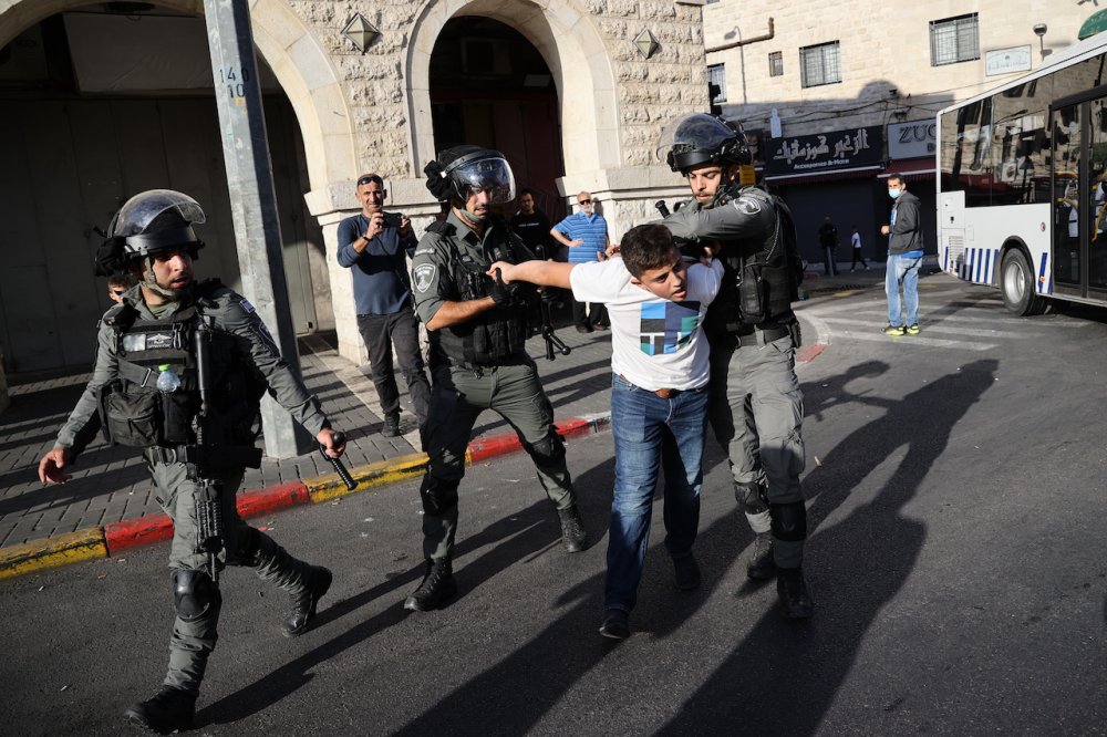 Israeli police arrest a Palestinian youth as Palestinian Muslims mark the birth of the Prophet Muhammad near the Jerusalem’s Old City, October 19, 2021.