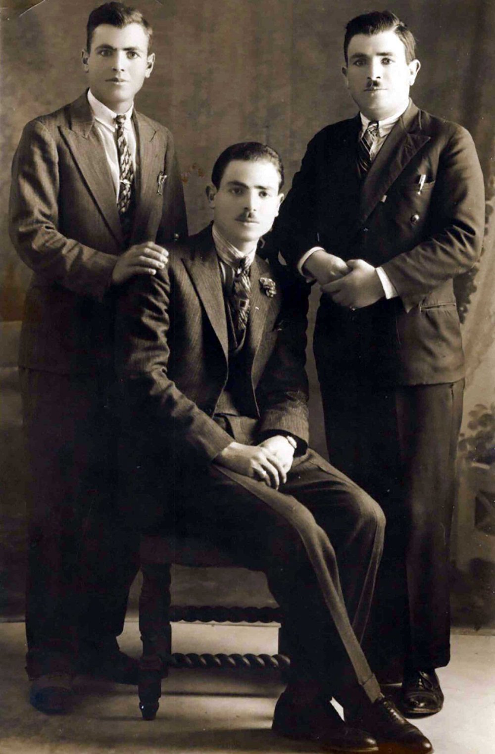 The Hammoudi brothers. Mohammad is seated; brothers Daoud (left) and Mousa stand behind him. 1930s. 
