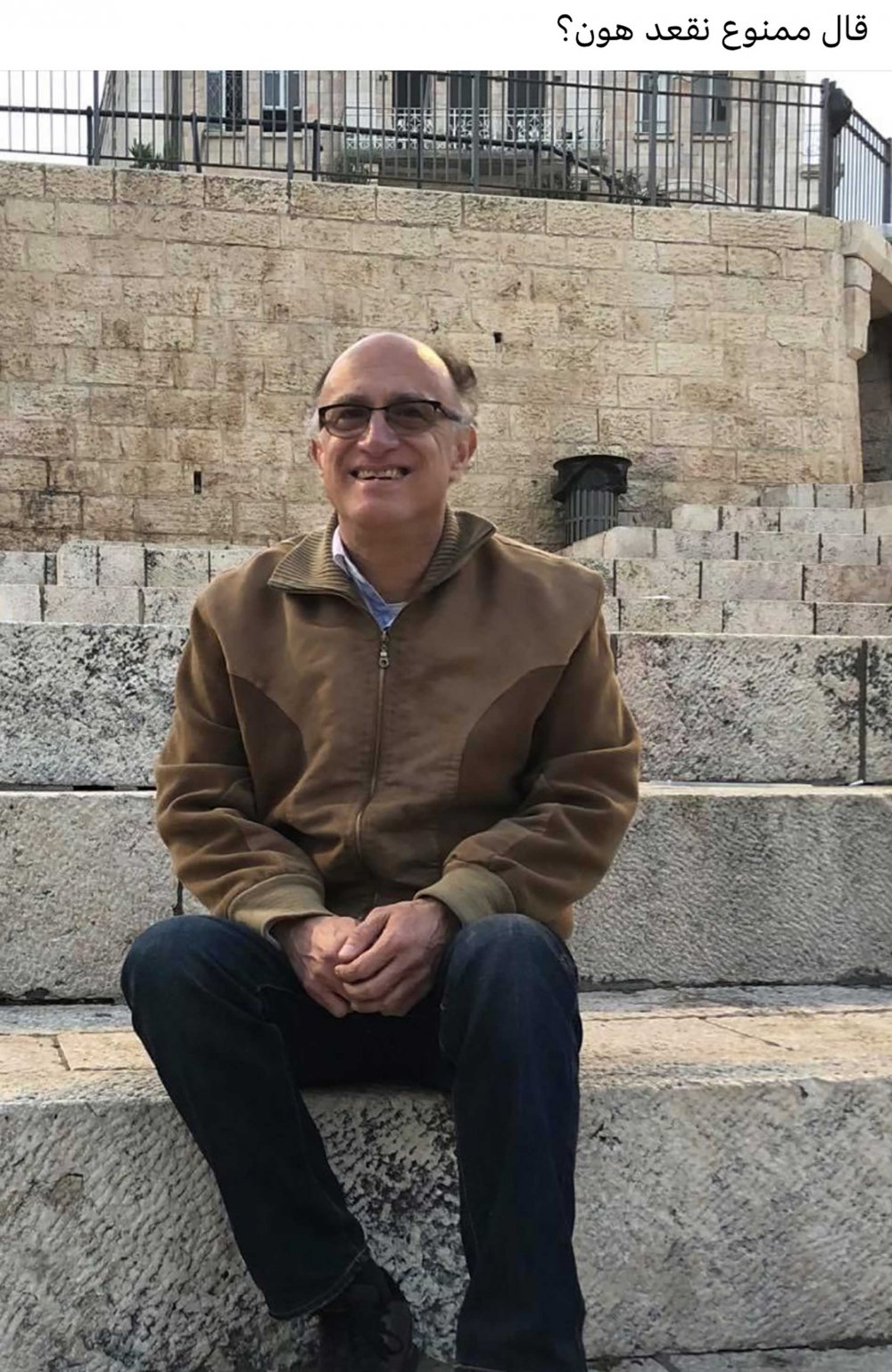George Sahhar responds to an Israeli order prohibiting Palestinians from sitting on the steps facing Damascus Gate by posting this photo of himself with the caption “Apparently we’re not allowed to sit here?”