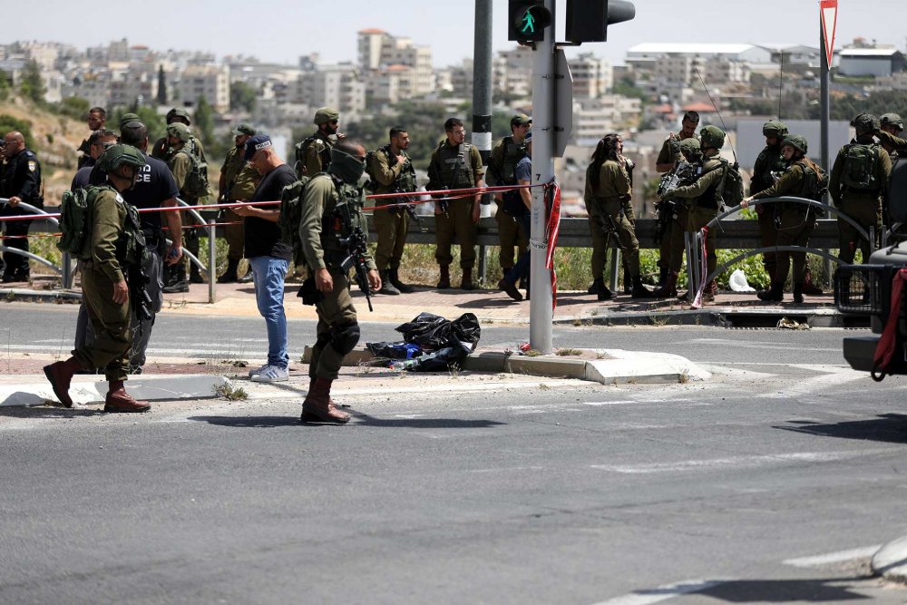 Israeli police gather after a Palestinian man was shot by Israeli security forces at a checkpoint south of Bethlehem, April 30, 2021.