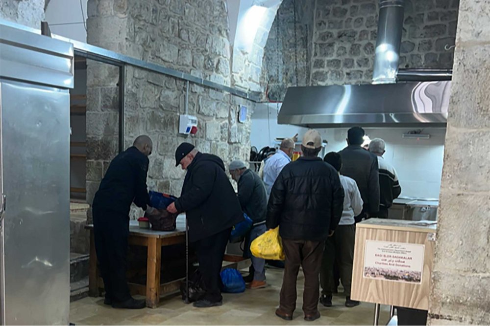 Palestinian Jerusalemites line up in the historic soup kitchen in Jerusalem’s Old City for a home-cooked meal to bring to their families, March 17, 2024. 
