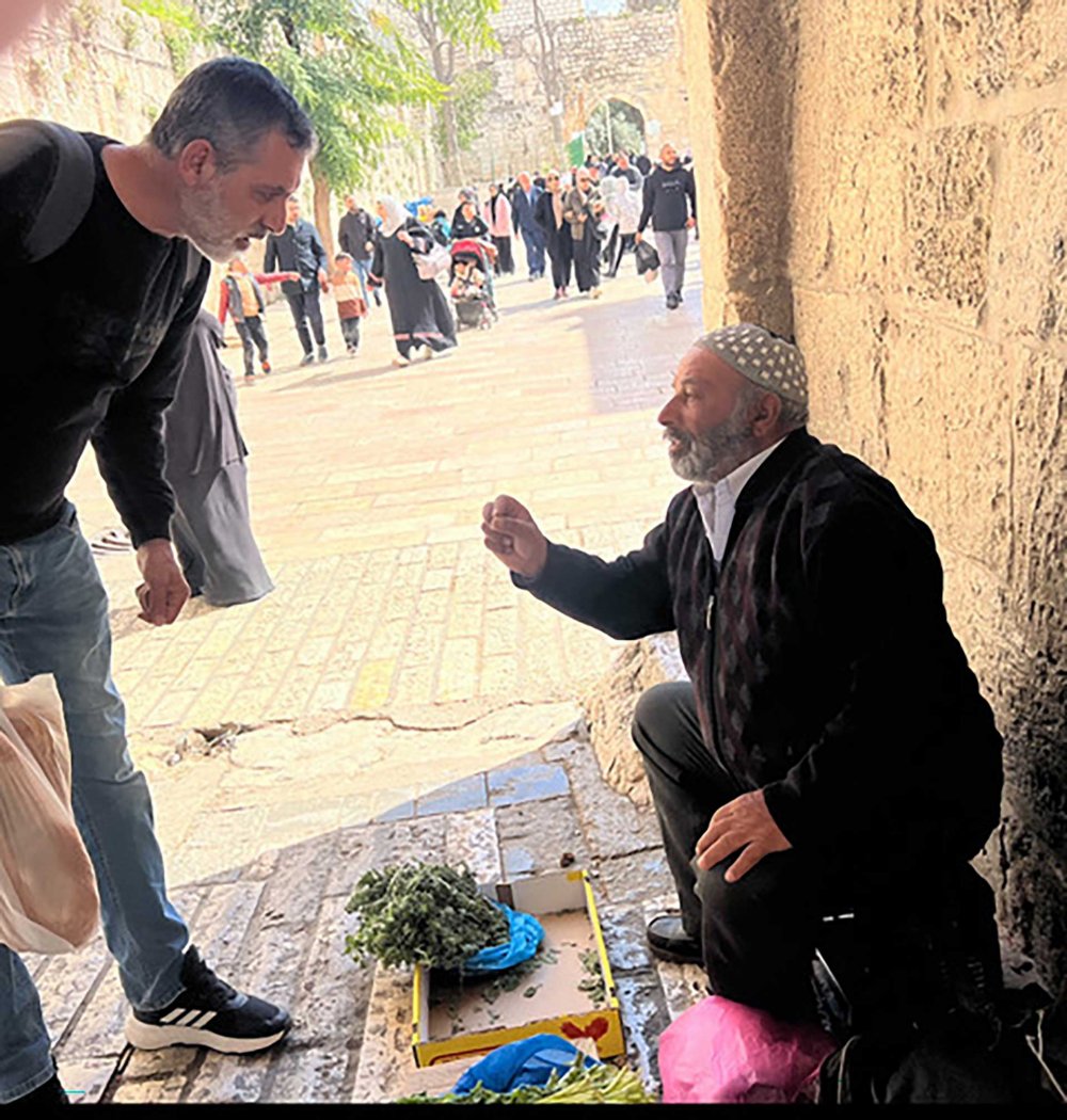 A Palestinian farmer from Bethlehem sells herbs near al-Aqsa Mosque on the second Friday of Ramadan, March 22, 2024. 