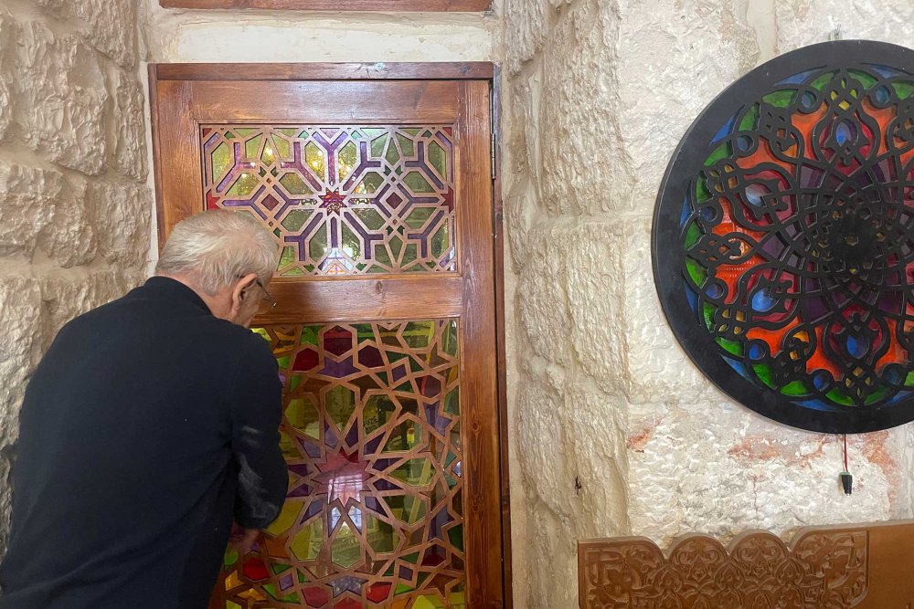 Azzam Abu Saud opening one of the doors to his studio in Jerusalem, March 21, 2024