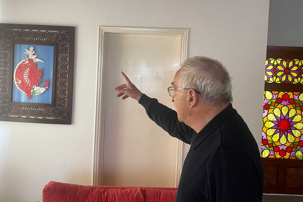 Azzam Abu Saud points at one of his artworks at his art studio in Ras al-Amud, East Jerusalem, March 21, 2024.
