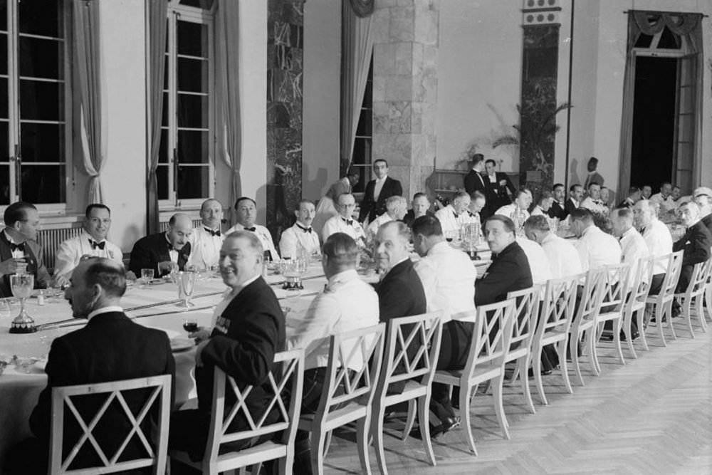Male guests sit at a long banquet table for a police event at the King David Hotel, May 20, 1939.