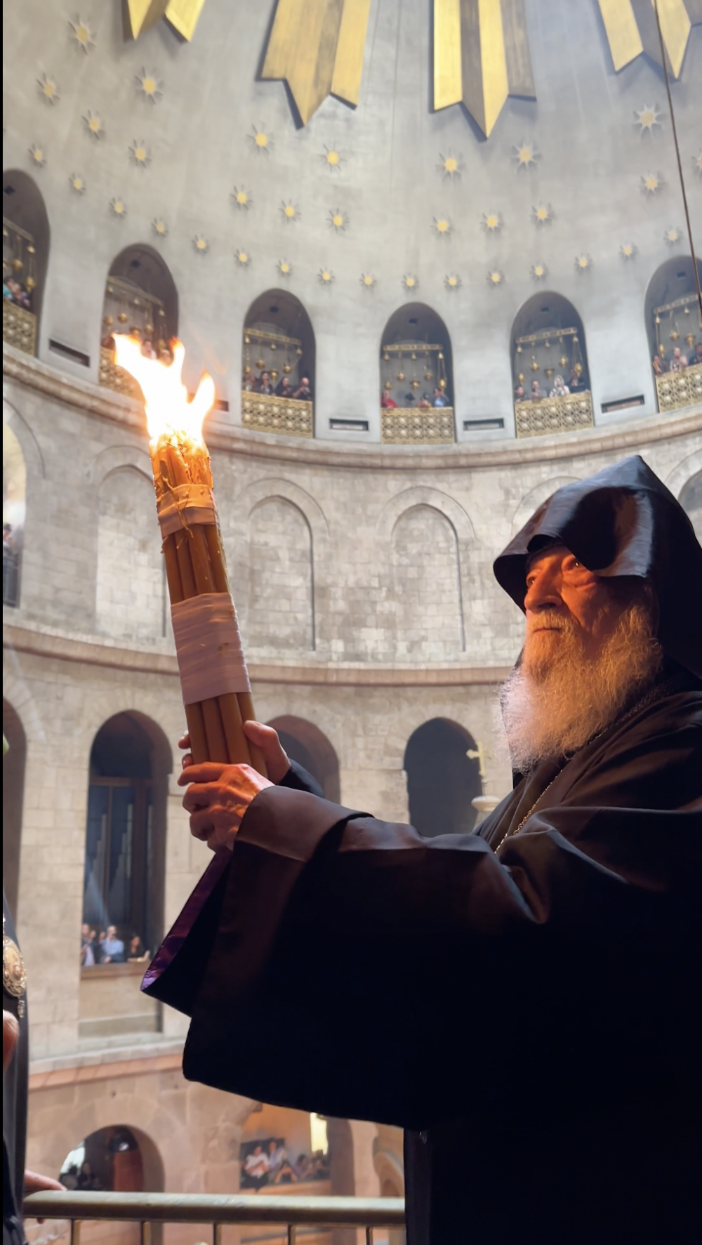 An orthodox priest holds a candle during the Holy Fire ceremony in the Church of the Holy Sepulchre, April 15, 2023