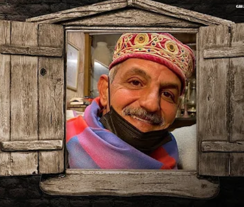 Portrait of Jerusalem storyteller Husam Abu Eisheh wearing a traditional hat